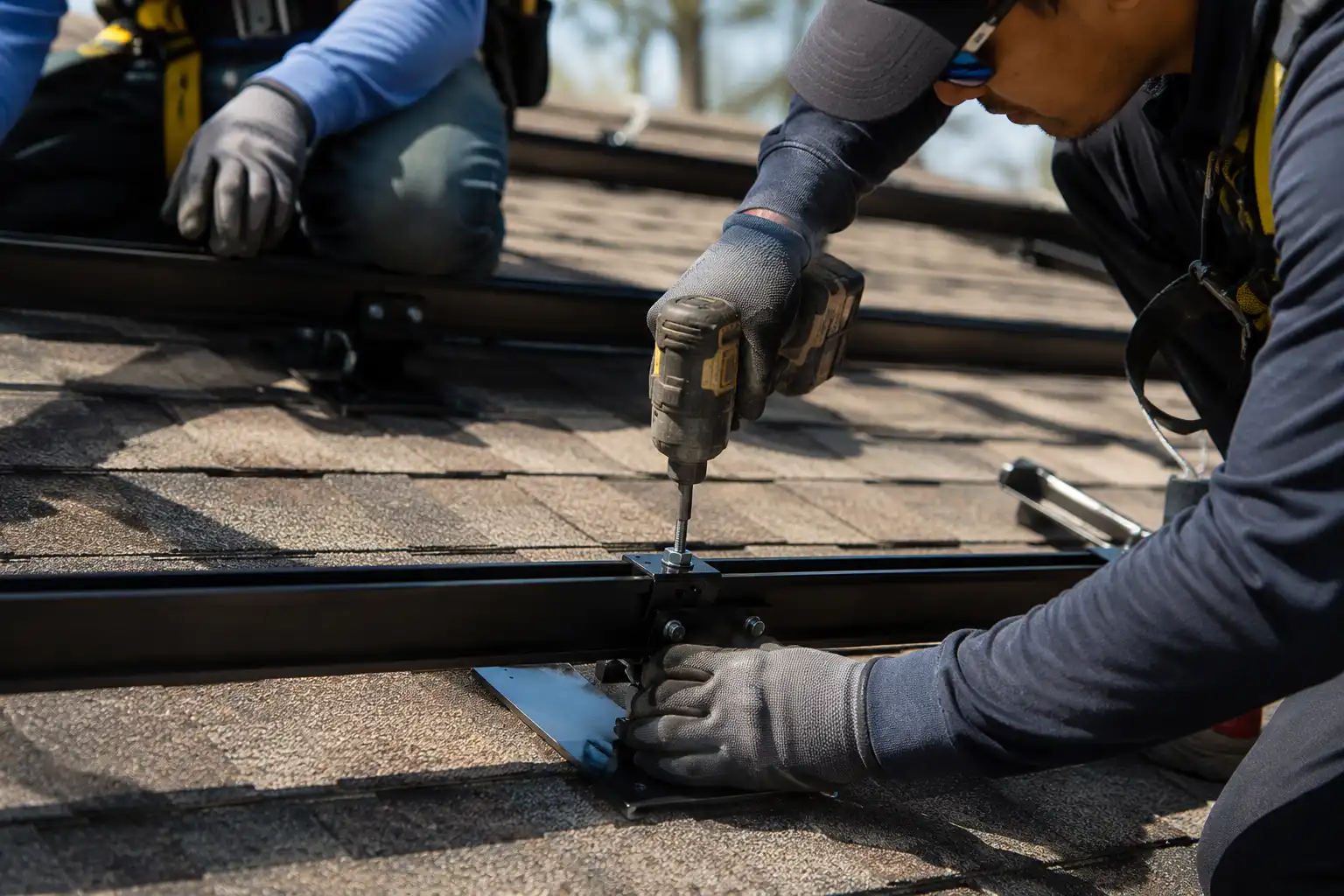 Installer securing residential solar panel hardware